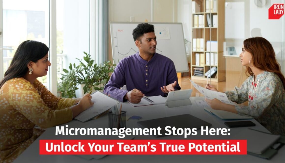 Three professionals in a meeting room discussing ideas around a table, with a whiteboard in the background.