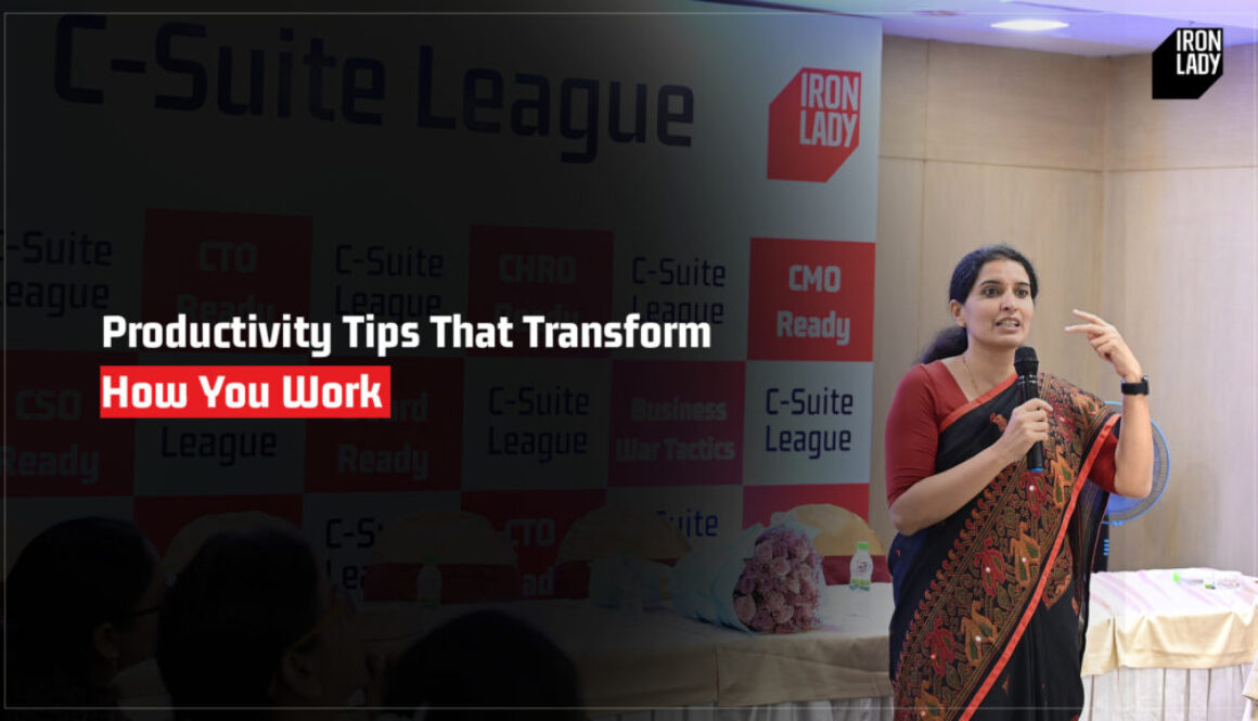 A professional speaker sharing actionable productivity tips during a leadership session, aimed at transforming how professionals work, with C-Suite League and Iron Lady branding in the background.